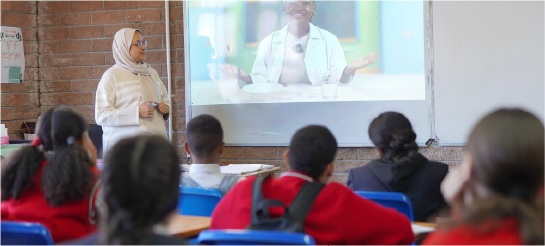 Teacher presenting a video lesson to learners in class
